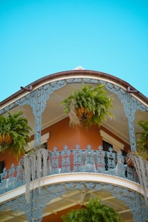 A building with a balcony and balconies with plants on the balconies