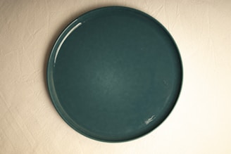 A green plate sitting on top of a table