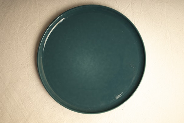A green plate sitting on top of a table