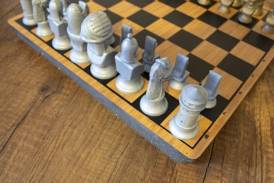 A wooden chess board with chess pieces on it