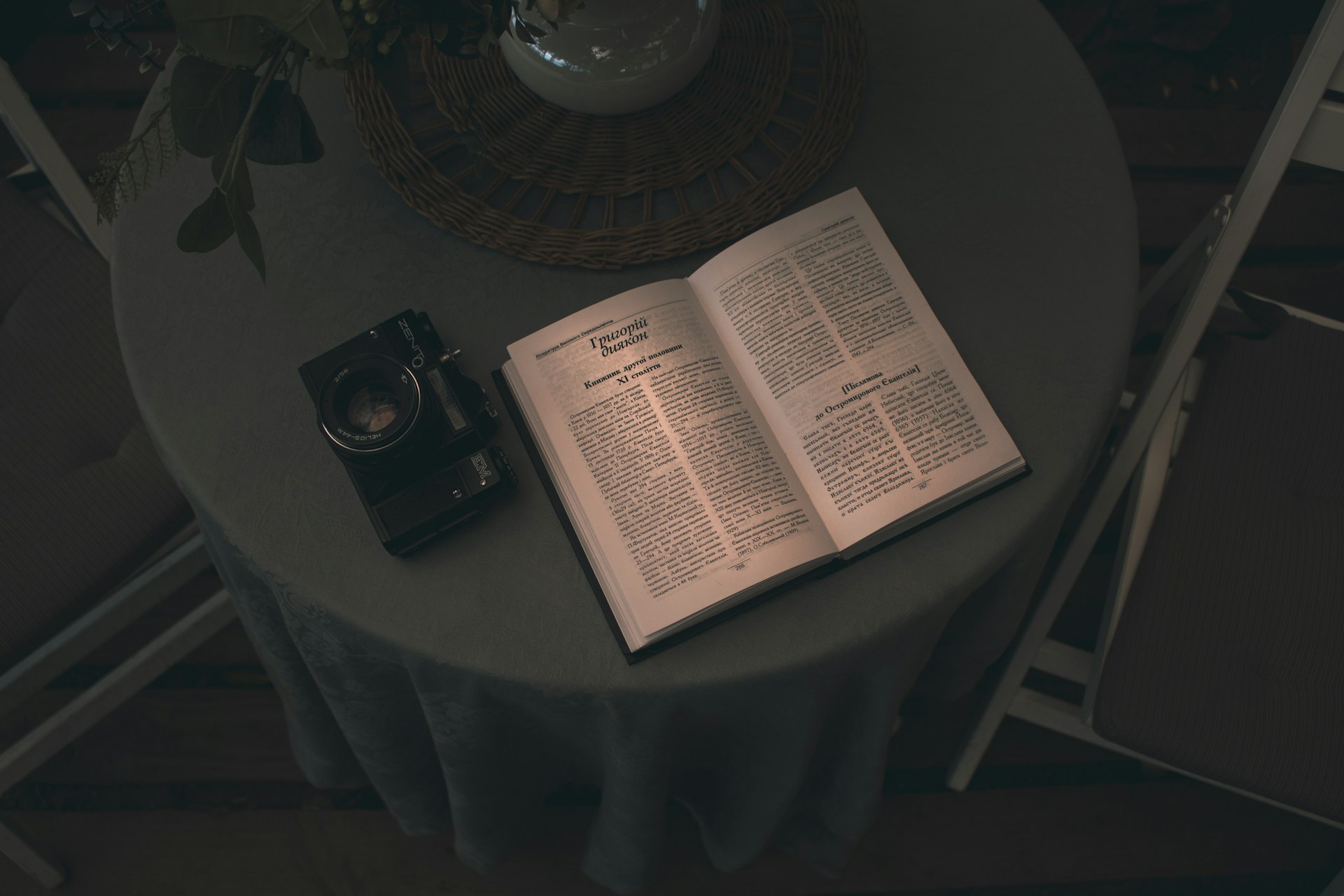 A table with a book and a camera on it