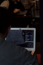 A man sitting in front of a laptop computer