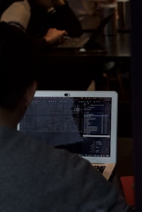 A man sitting in front of a laptop computer
