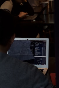 A man sitting in front of a laptop computer