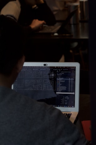 A man sitting in front of a laptop computer