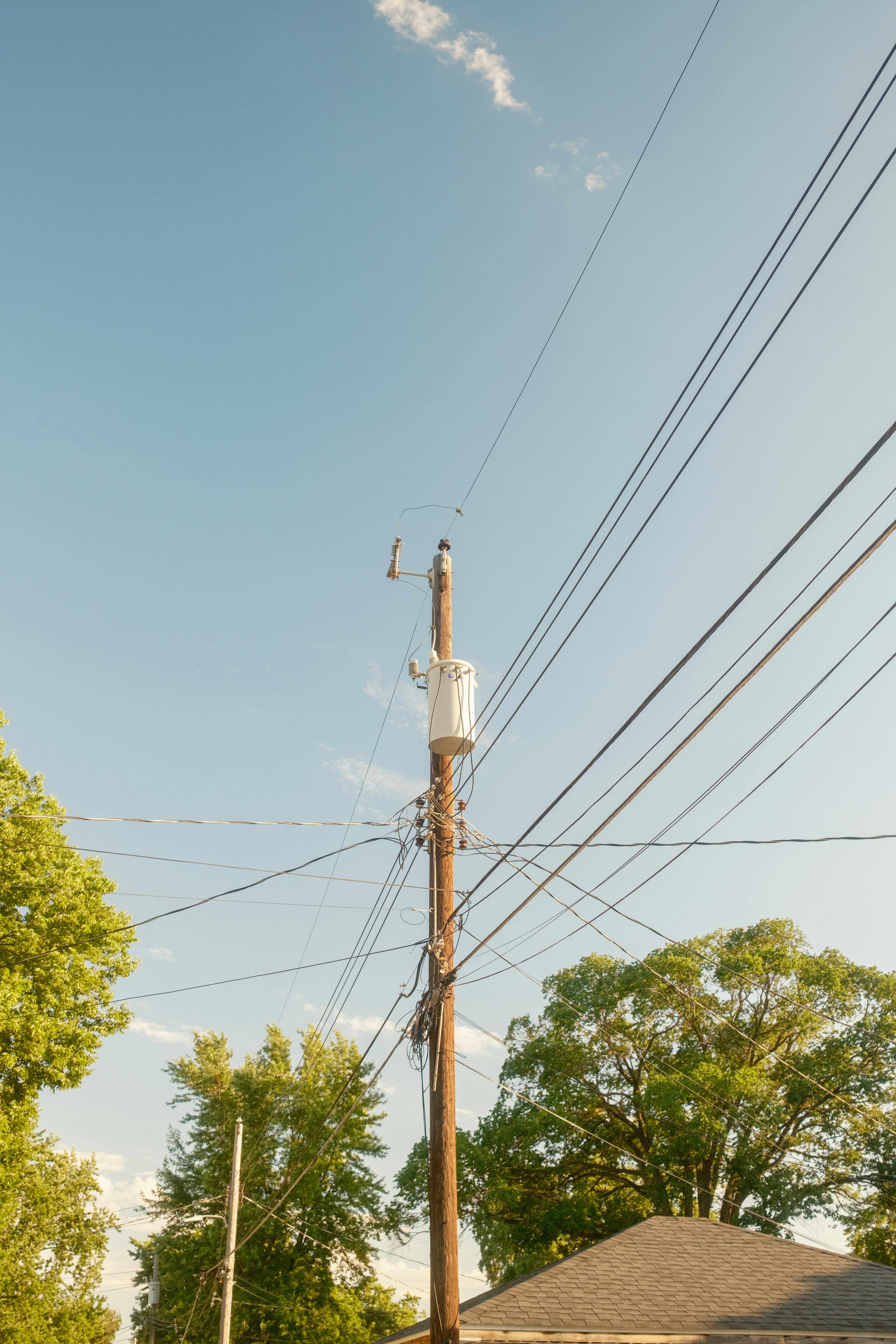 A telephone pole in the middle of a street