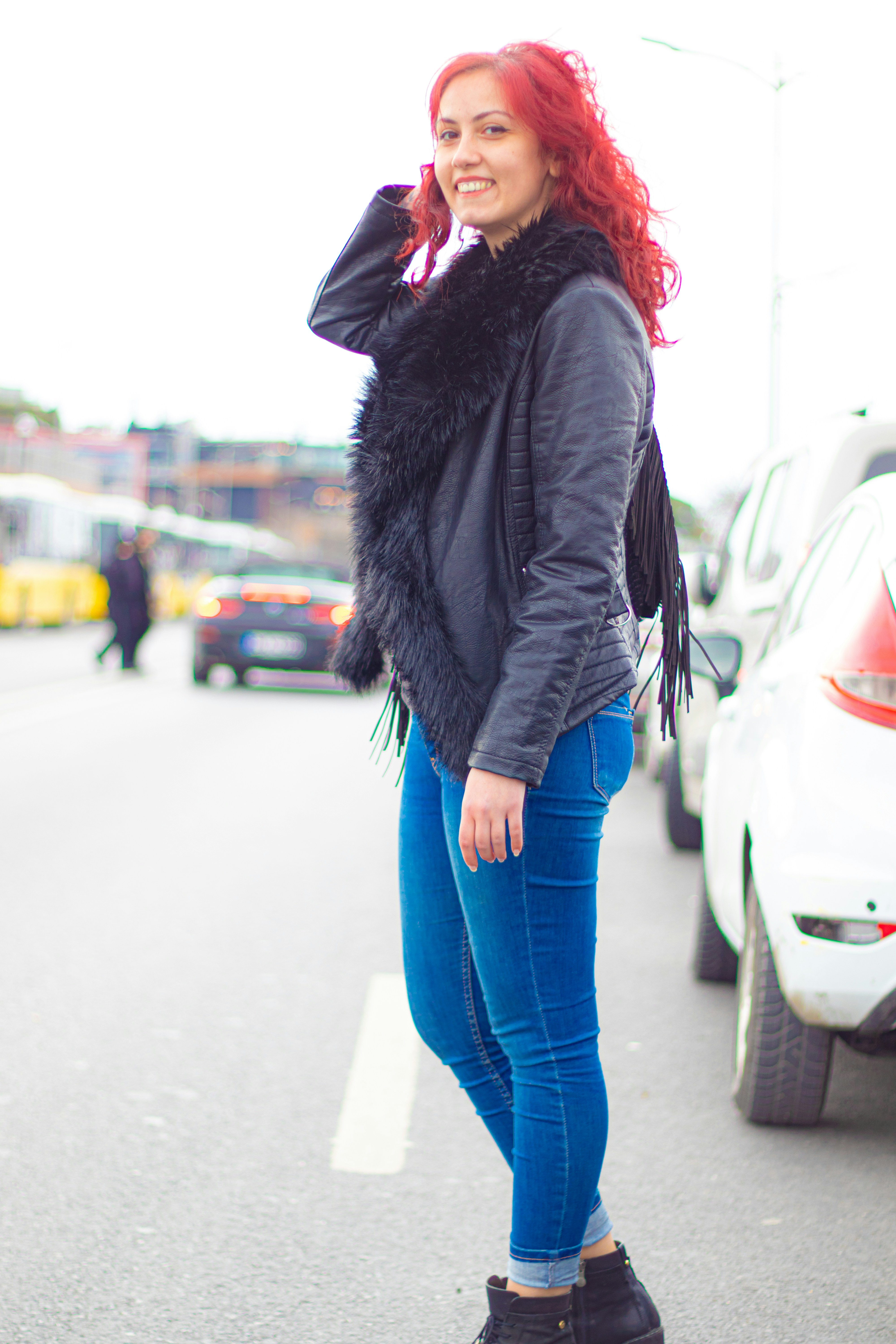 Young woman with long blonde hair smiling outdoors