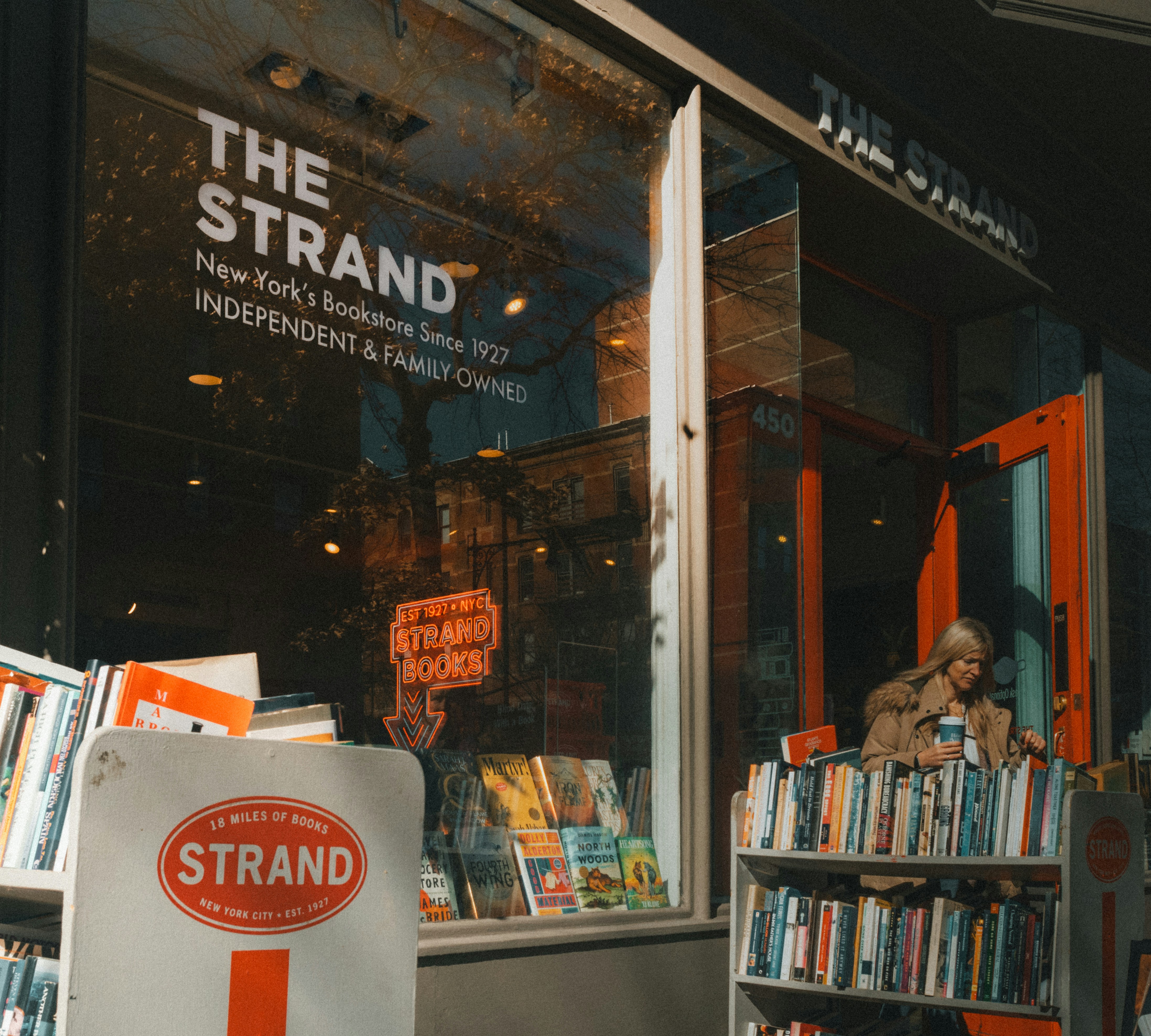 A book store with a sign in front of it