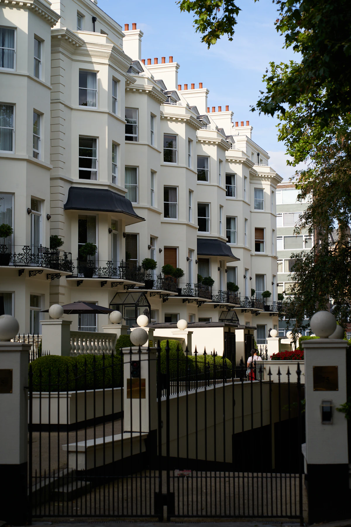 White stucco apartment terraces with balconies in Kensington, London