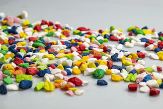 A pile of colorful candy corn on a white surface