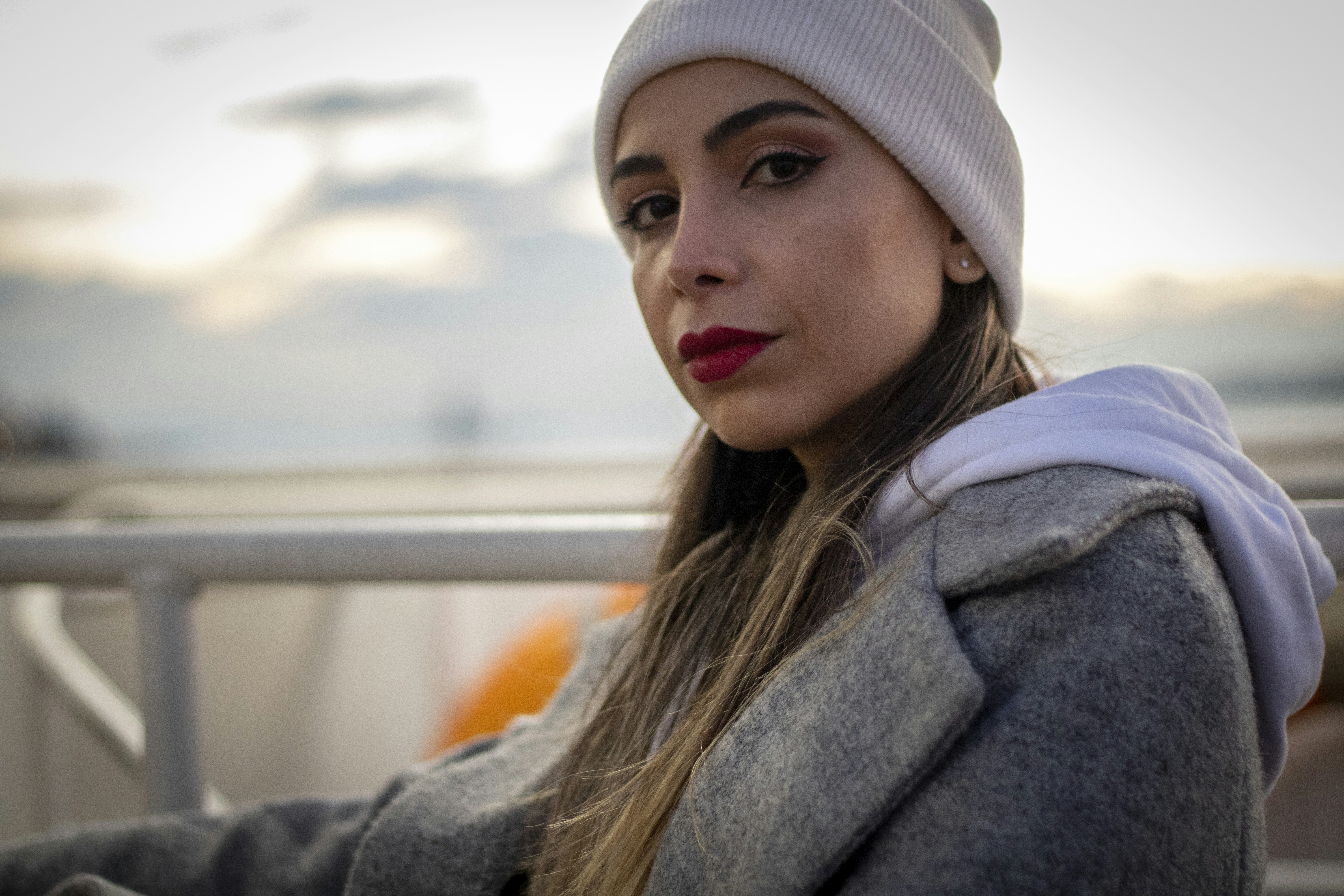 A woman with a white hat and a gray jacket