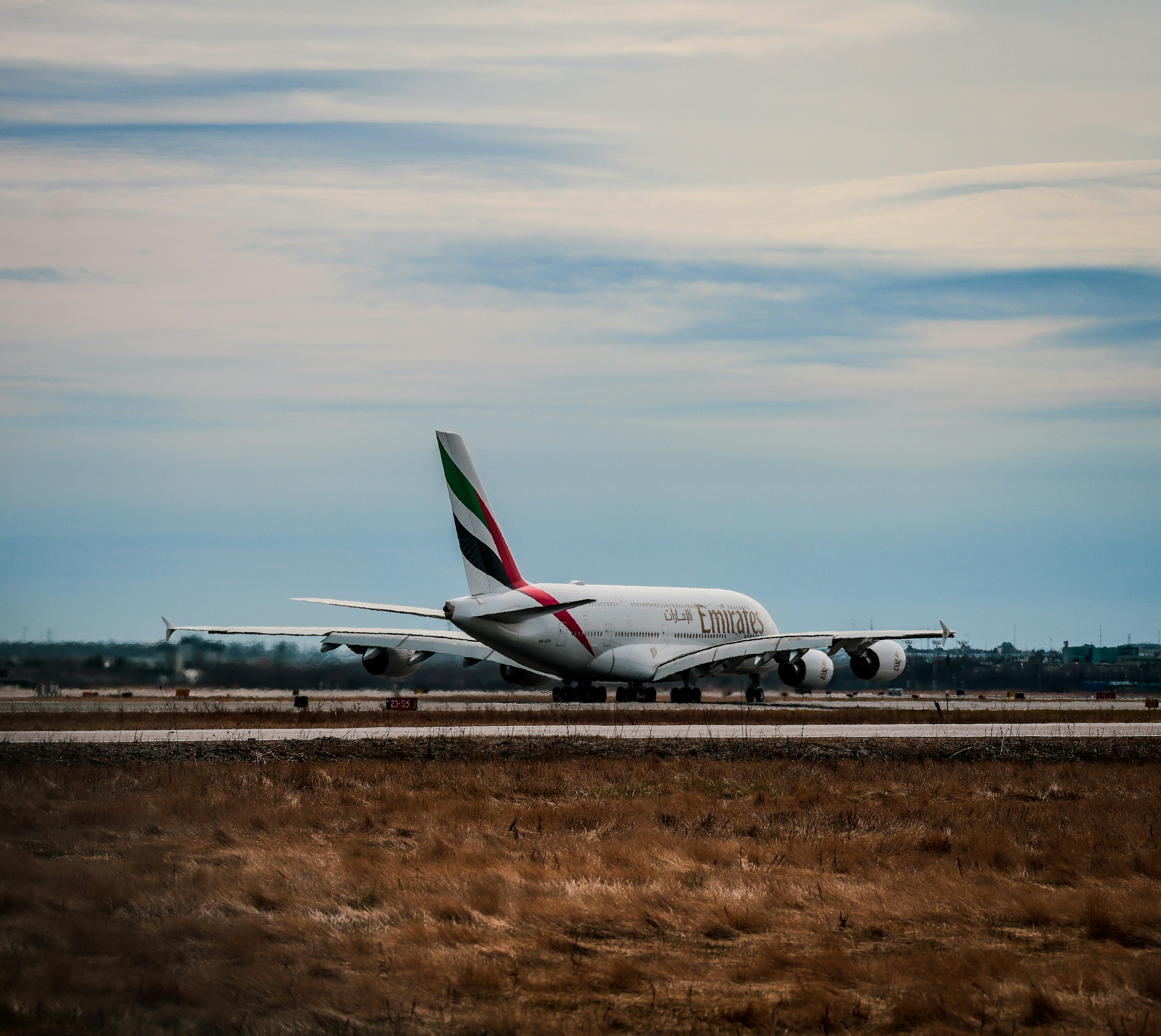 A large jetliner sitting on top of an airport runway, 