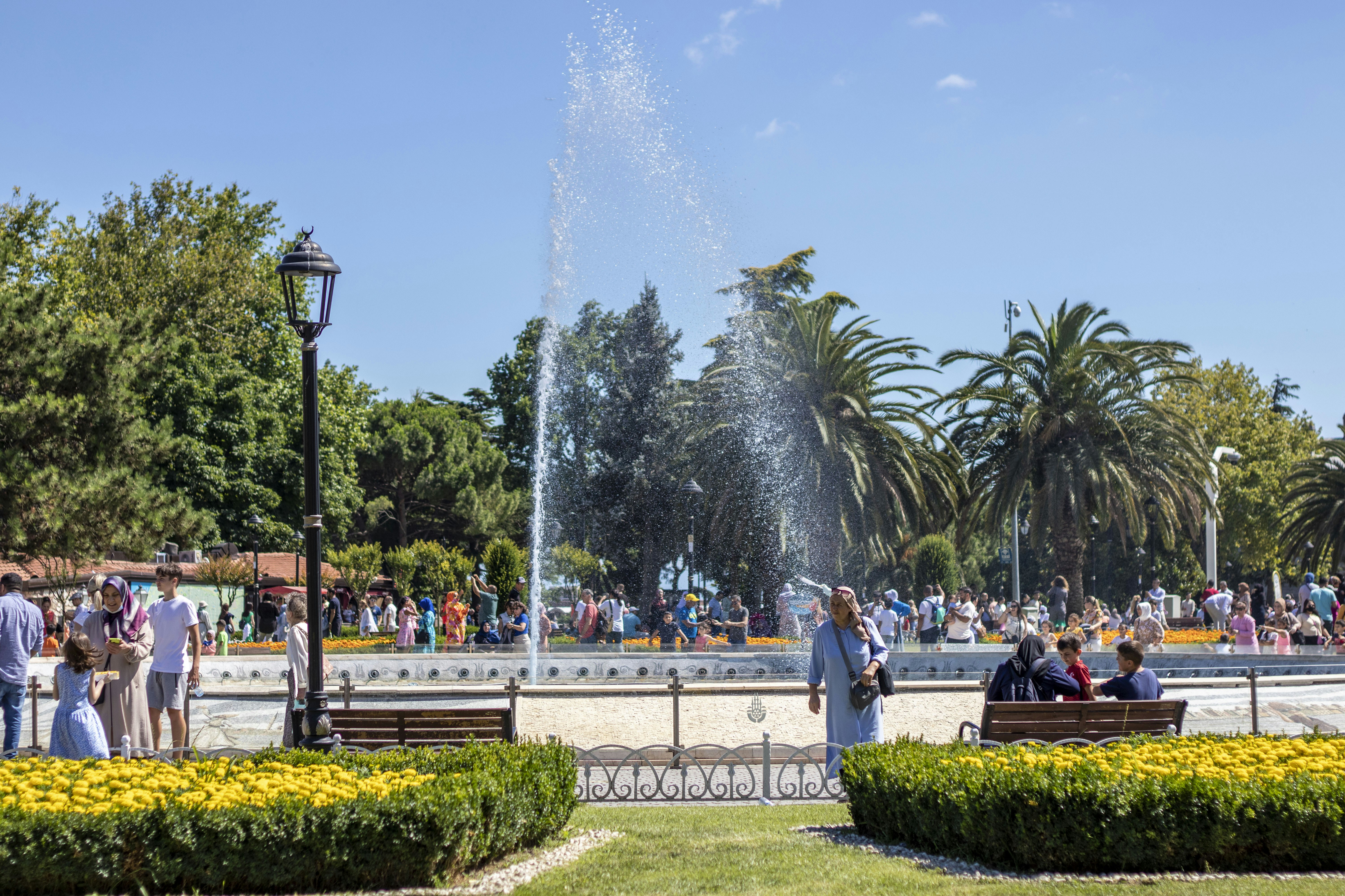 A group of people standing around a fountain