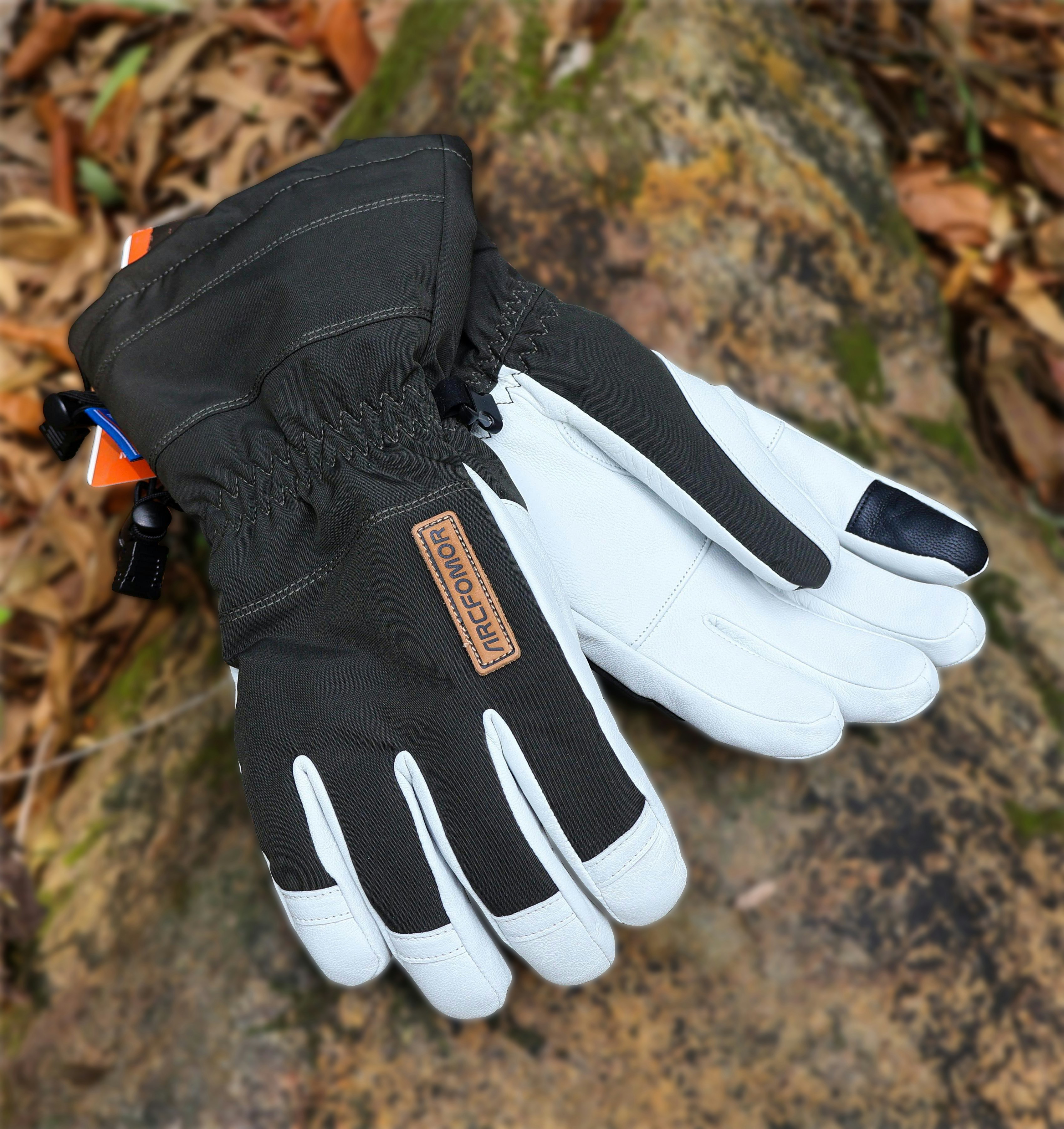 Premium wool liner gloves in charcoal on clean white surface with pine branch accent