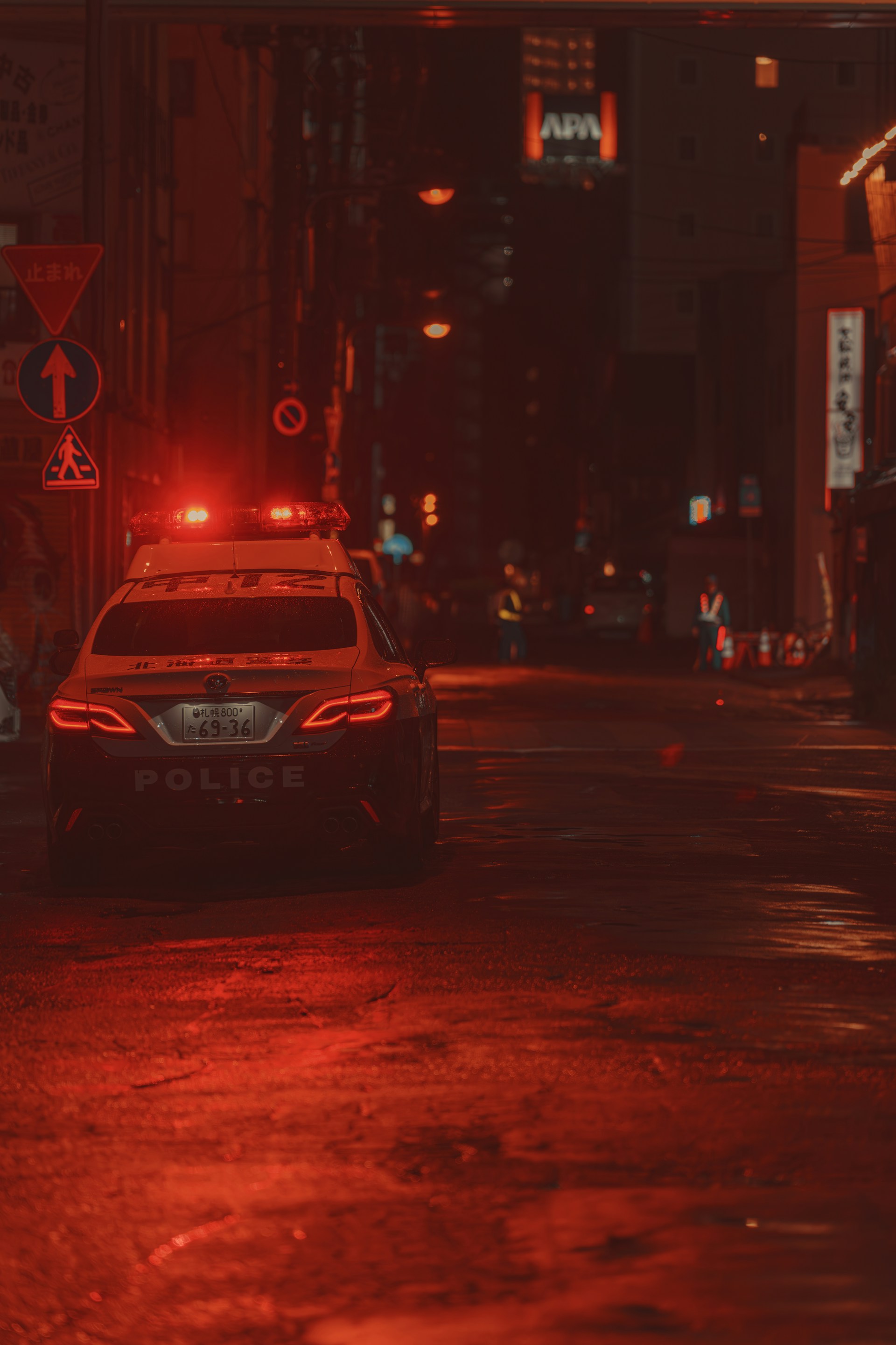 A police car parked on a city street at night