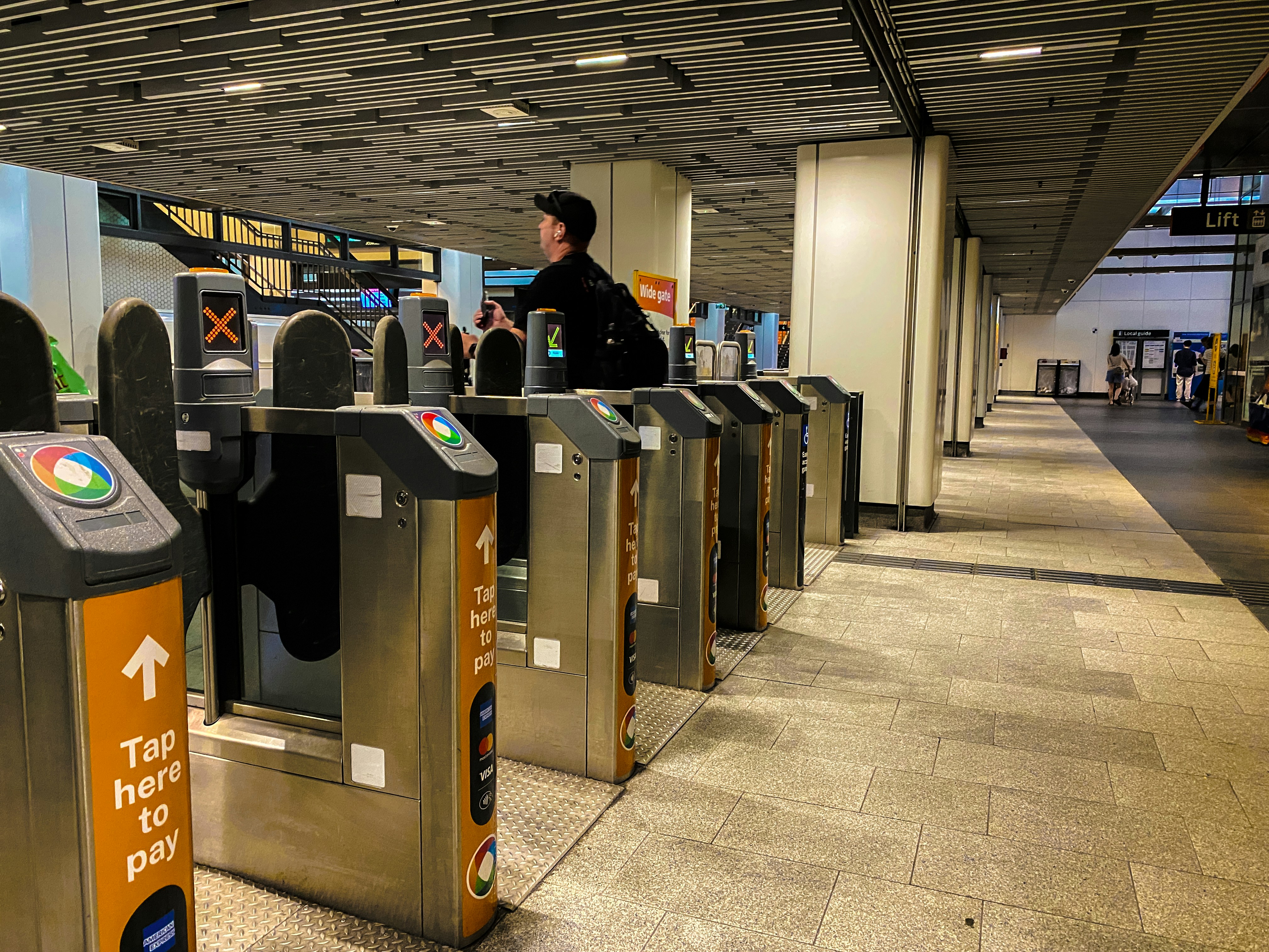 A security officer is standing at the check in area