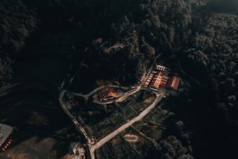 An aerial view of a building in the middle of a forest