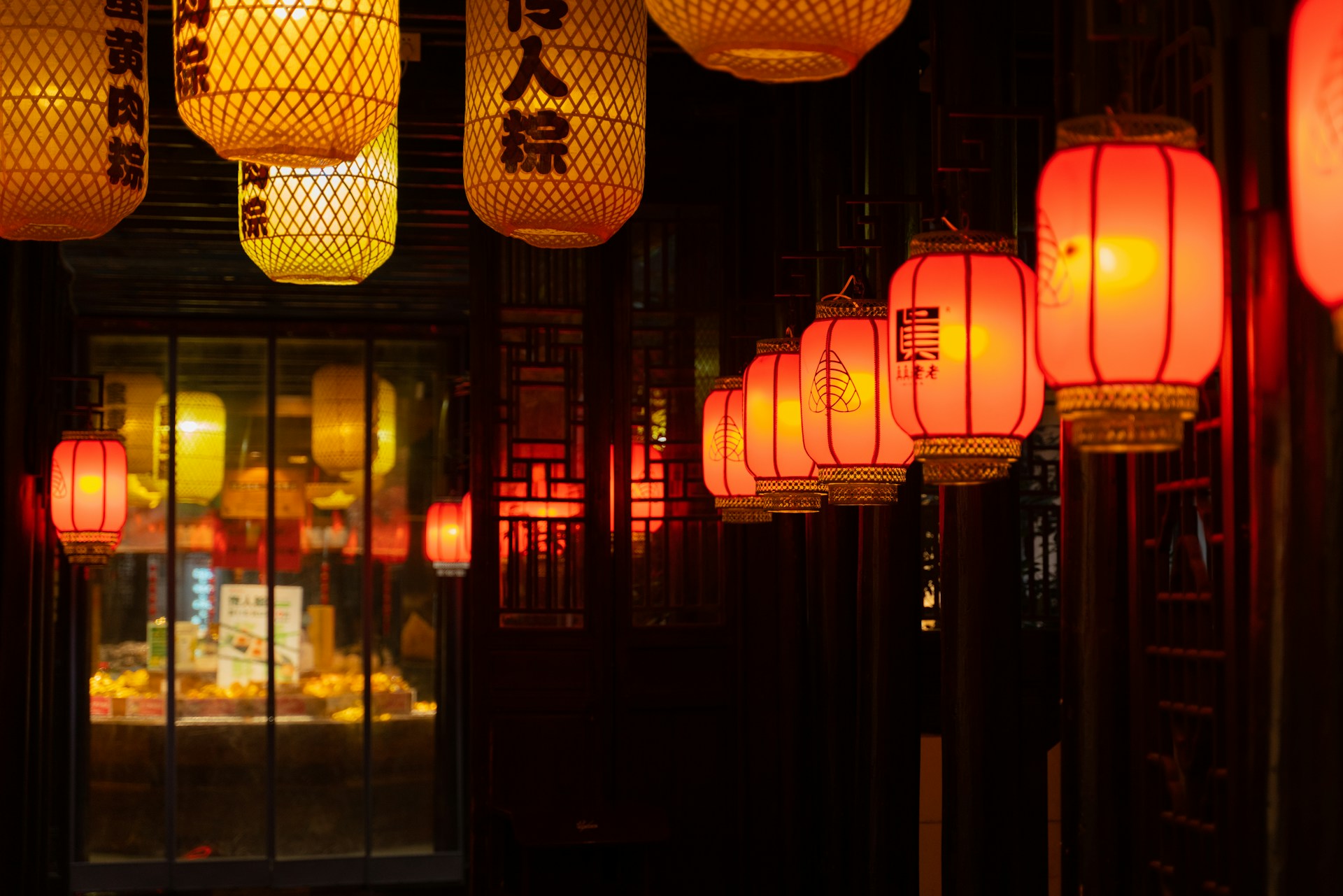 A number of lanterns hanging from a ceiling