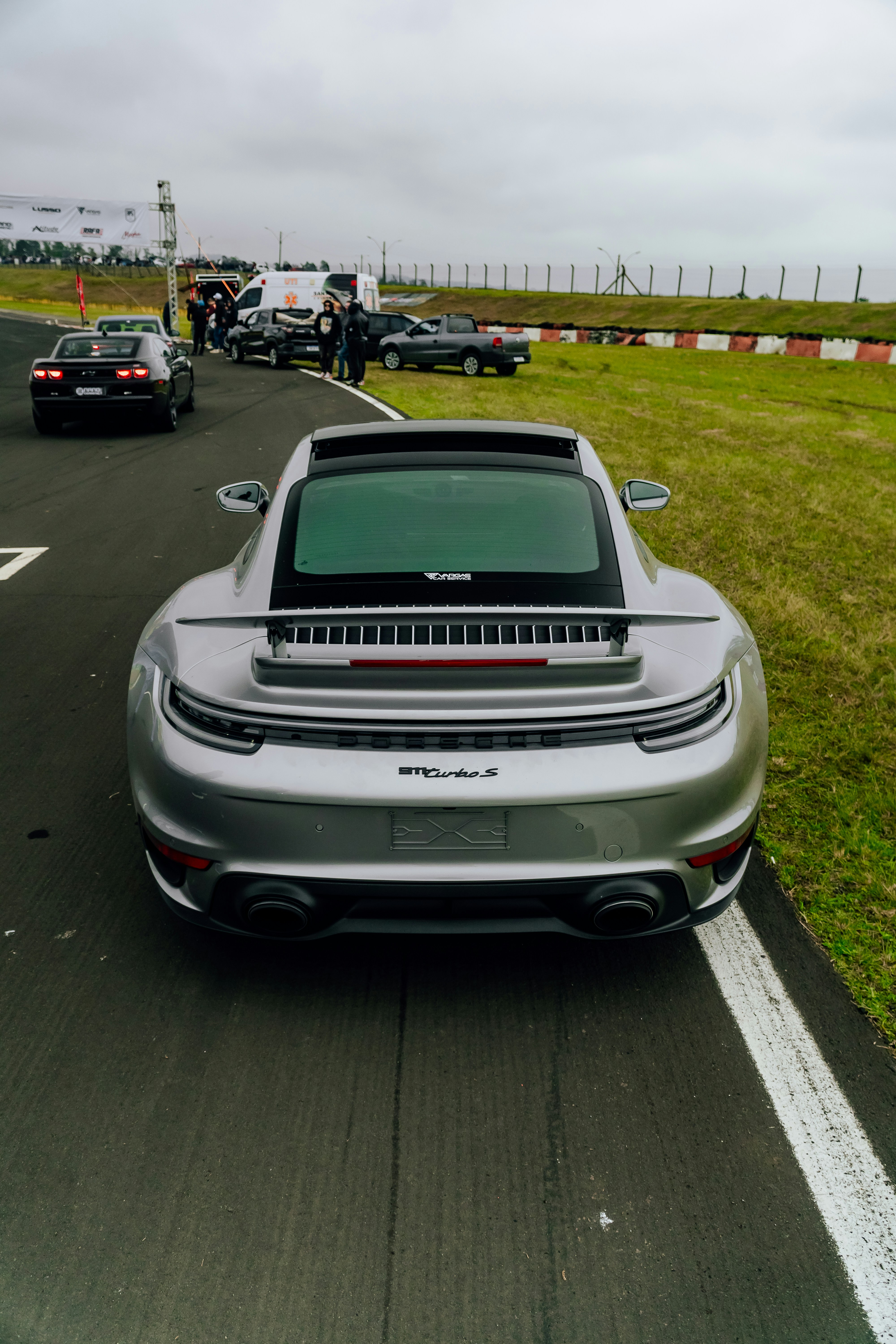 2024 Porsche 911 Turbo S in silver, side profile on a race track