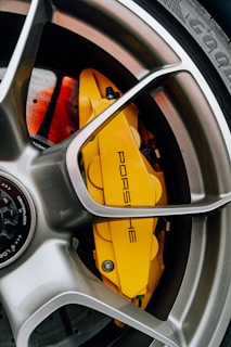 A close up of a yellow brake on a car