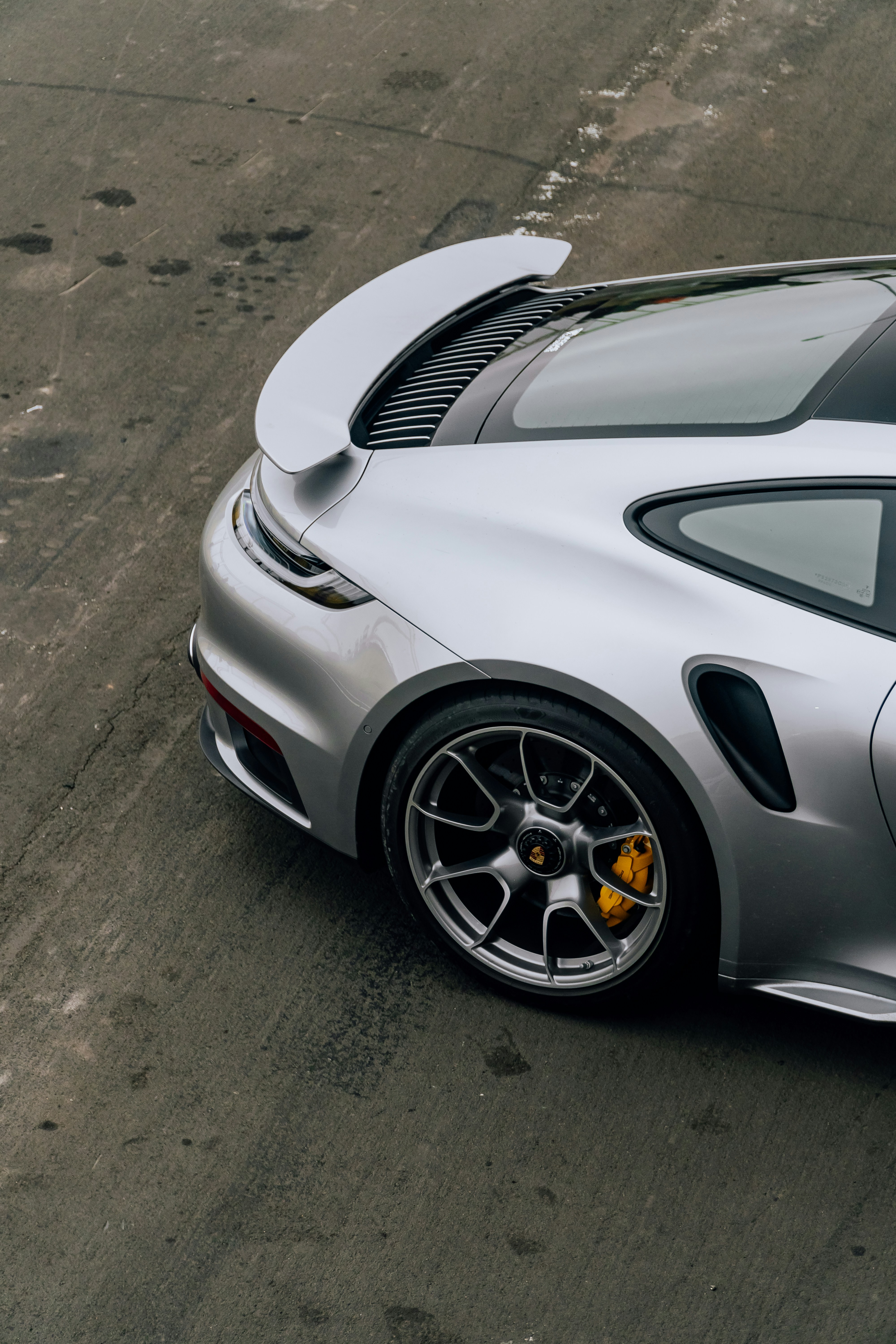 A silver sports car parked in a parking lot
