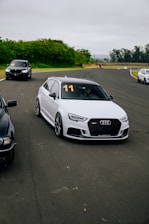 A group of cars driving down a race track