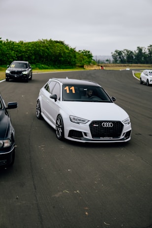 A group of cars driving down a race track