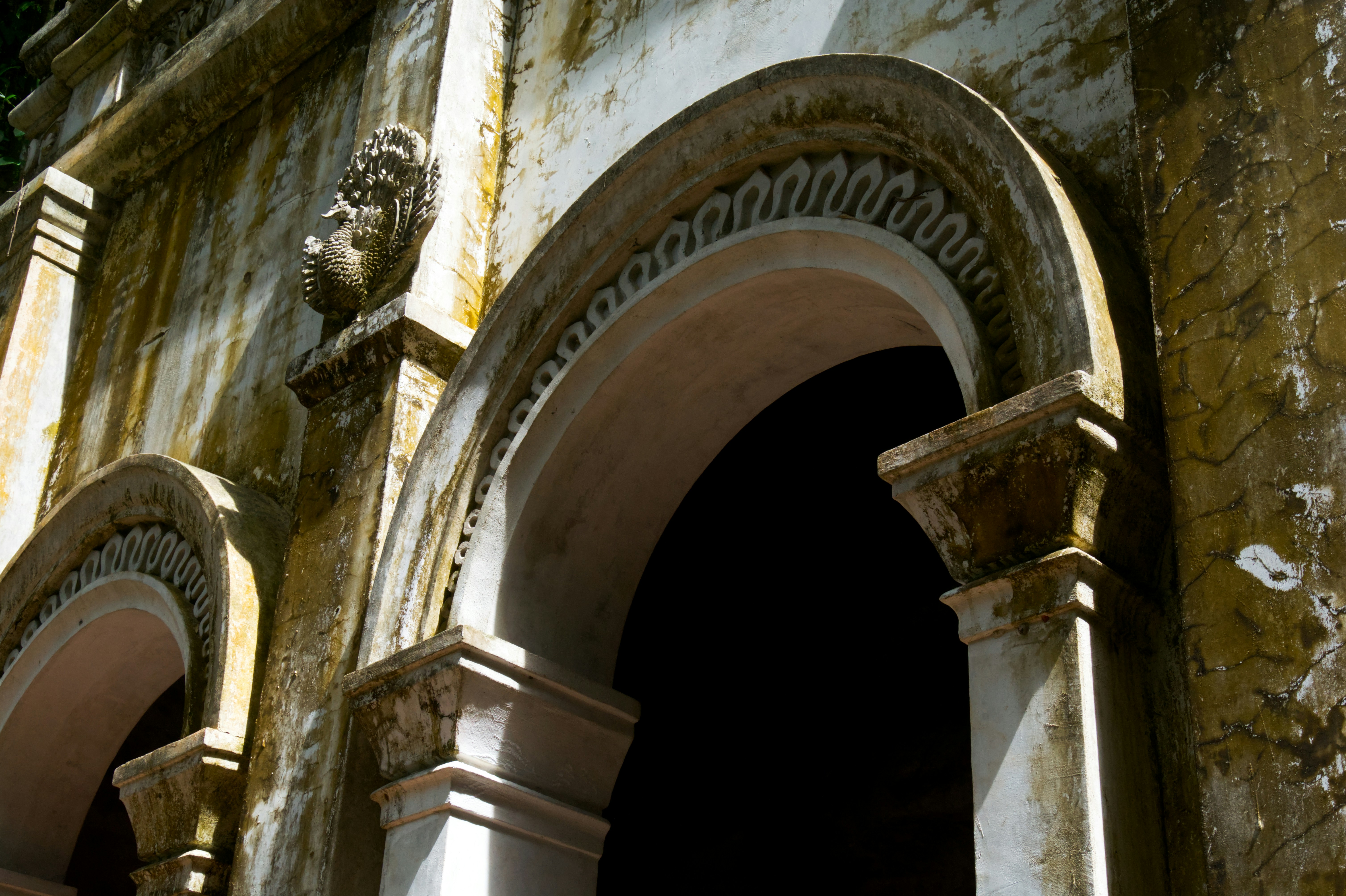 An old building with a statue of a lion on the side of it