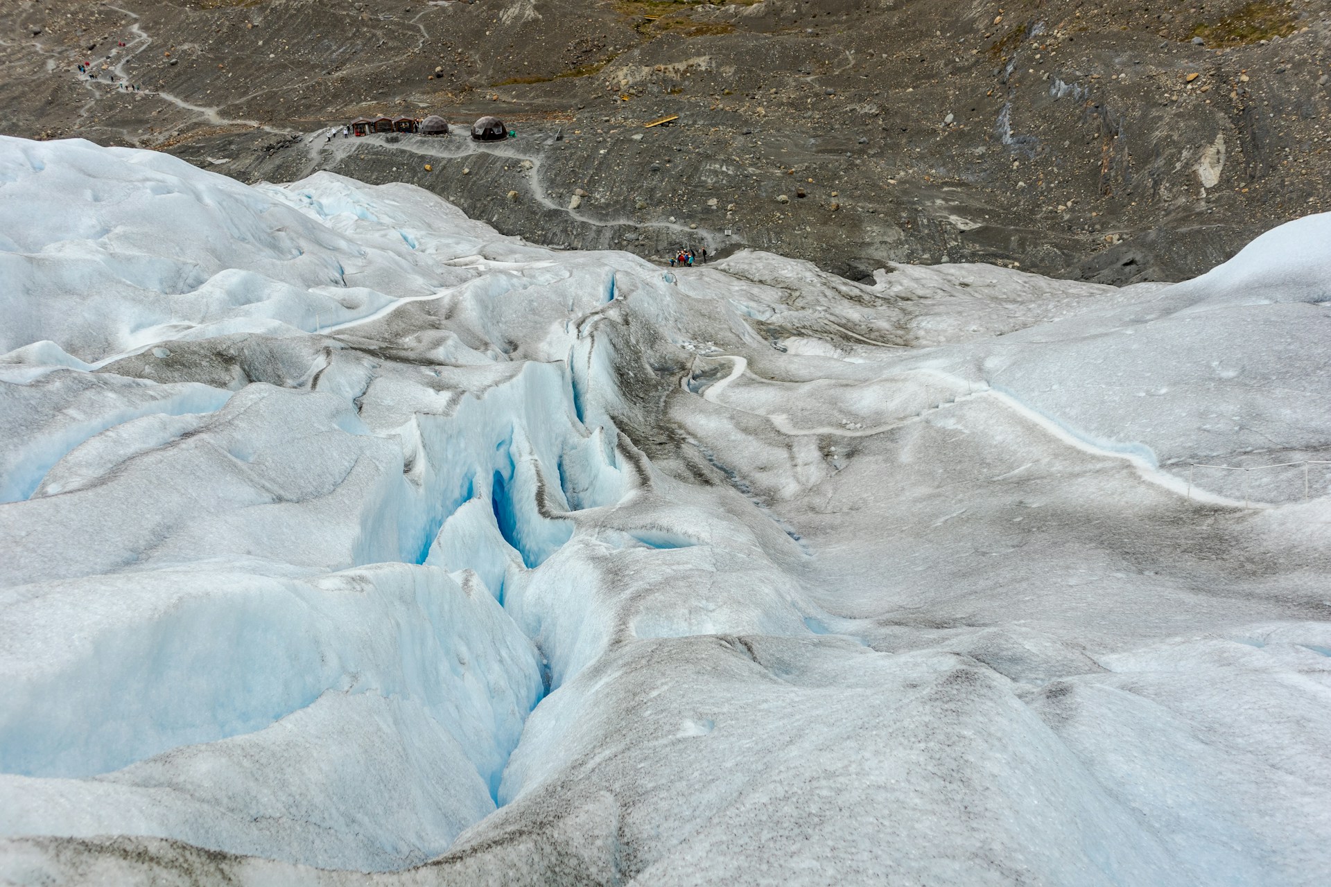 A group of people standing on top of a glacier