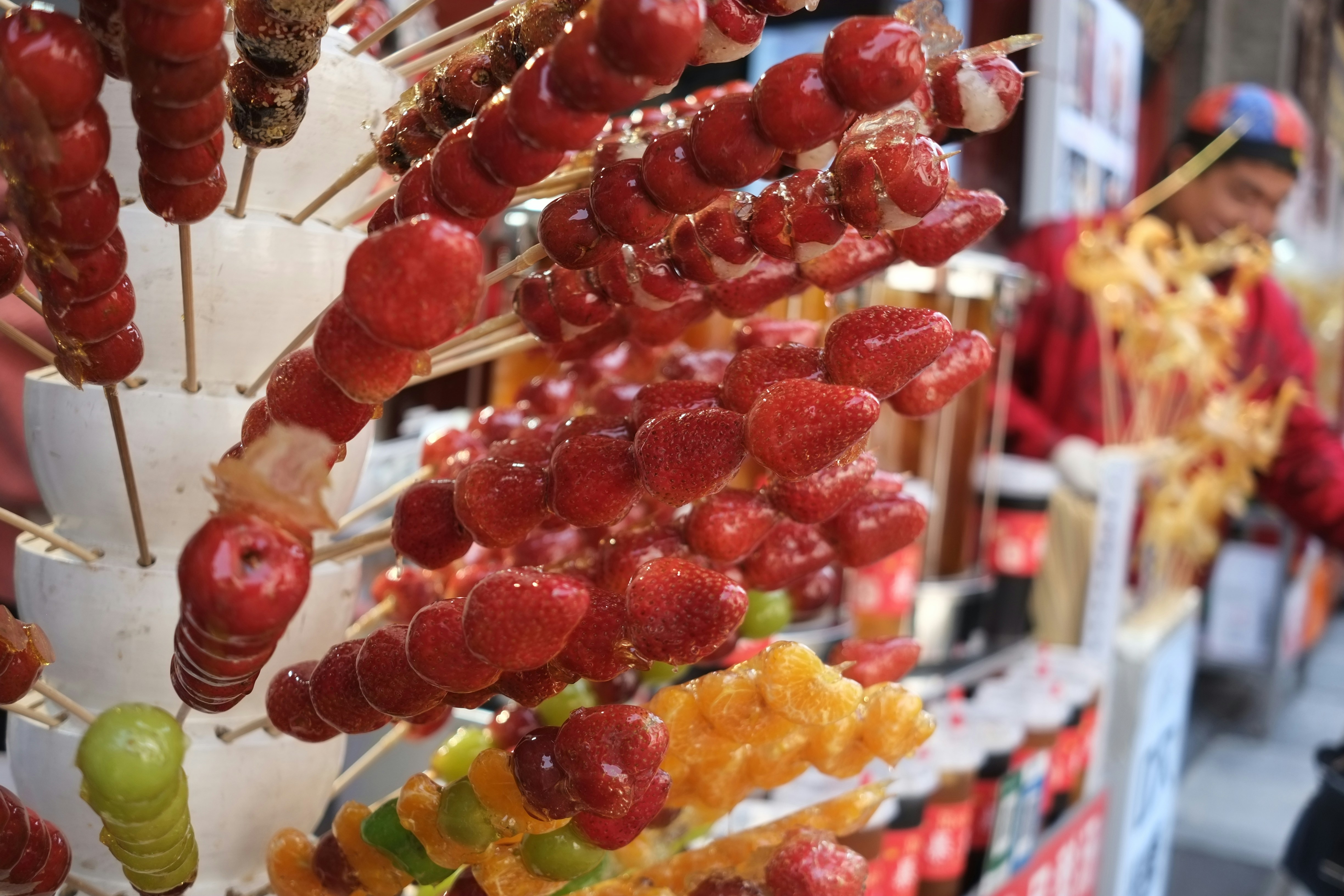 Candied fruit skewers on display
