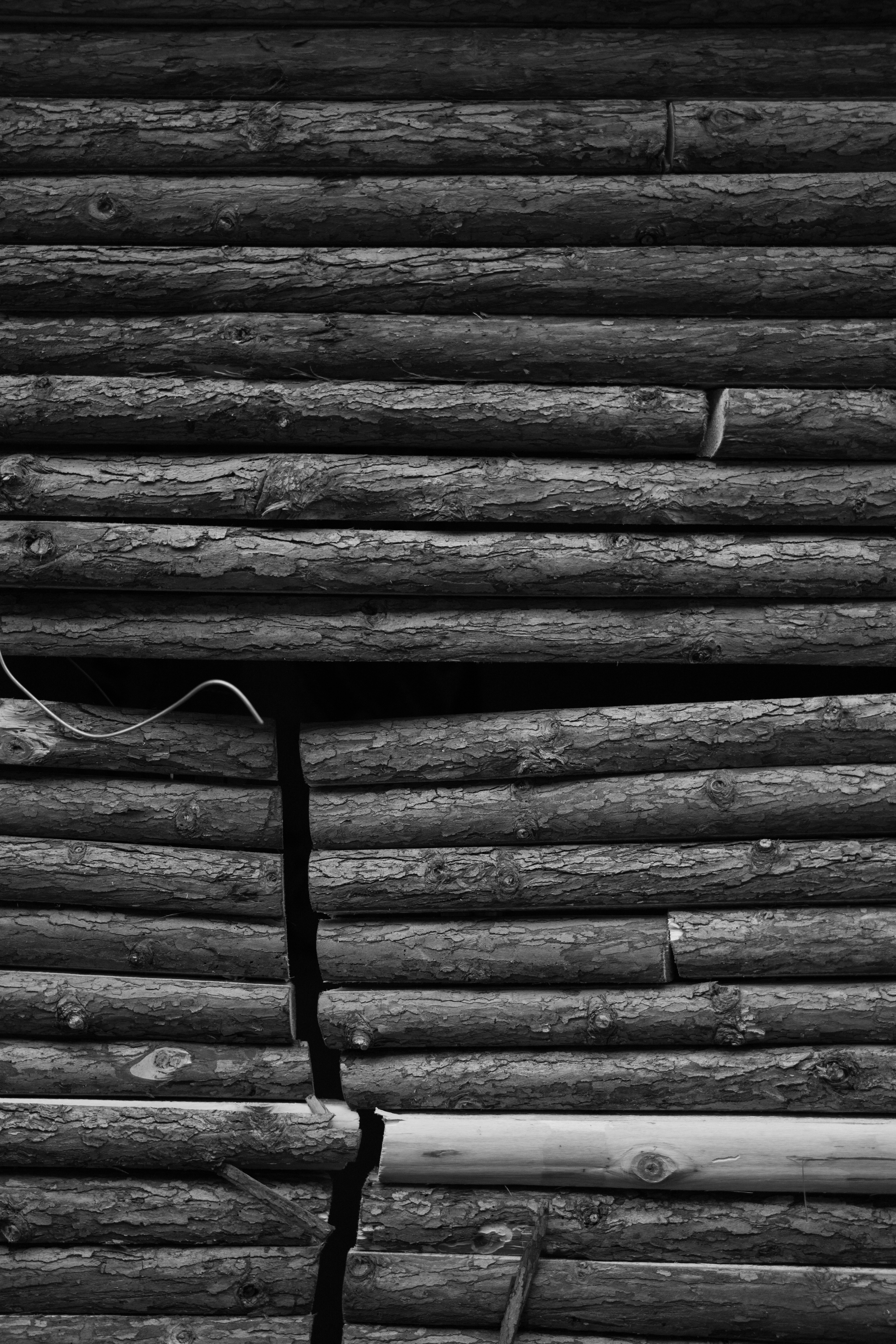 A black and white photo of a pile of logs