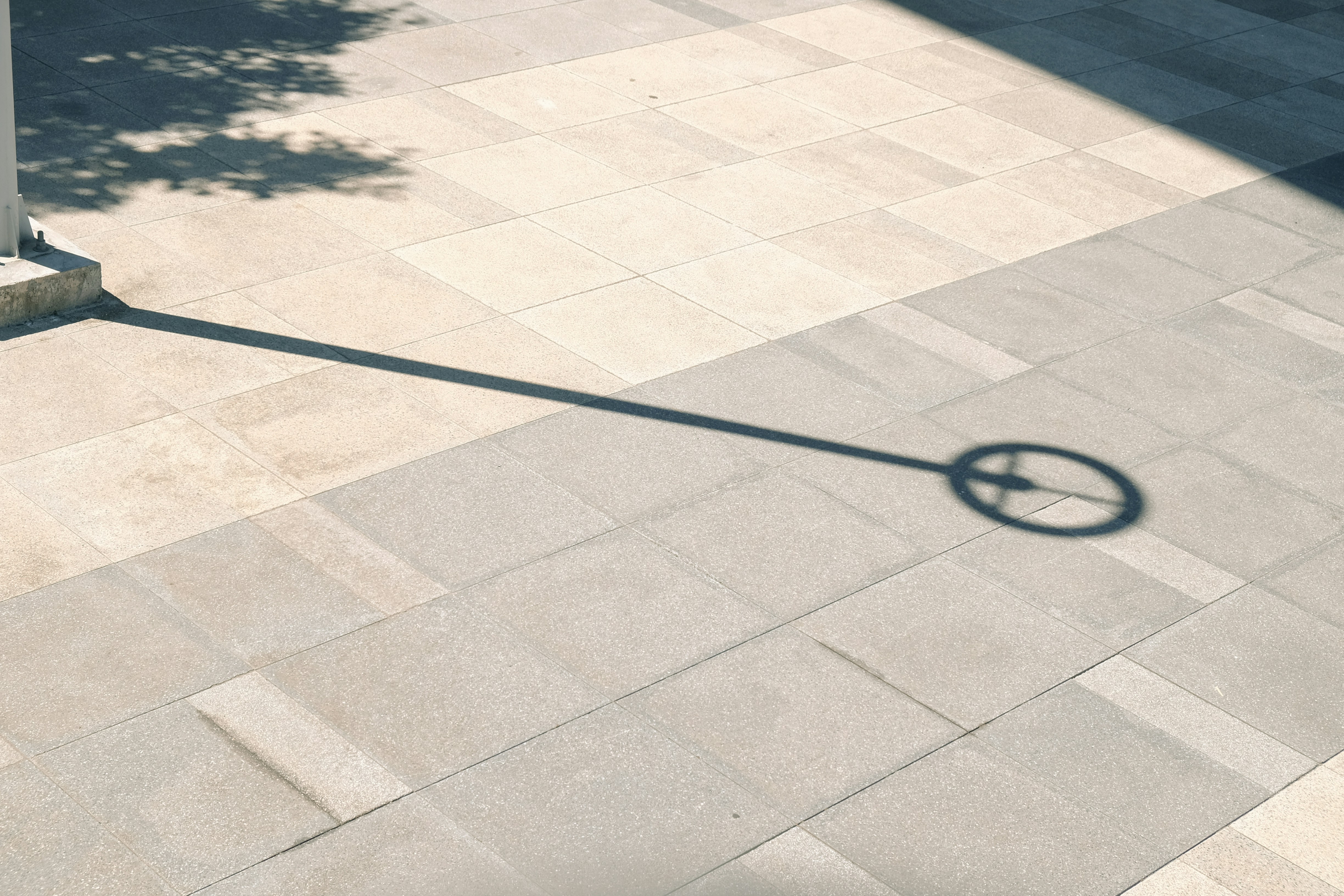 A man riding a skateboard down a sidewalk