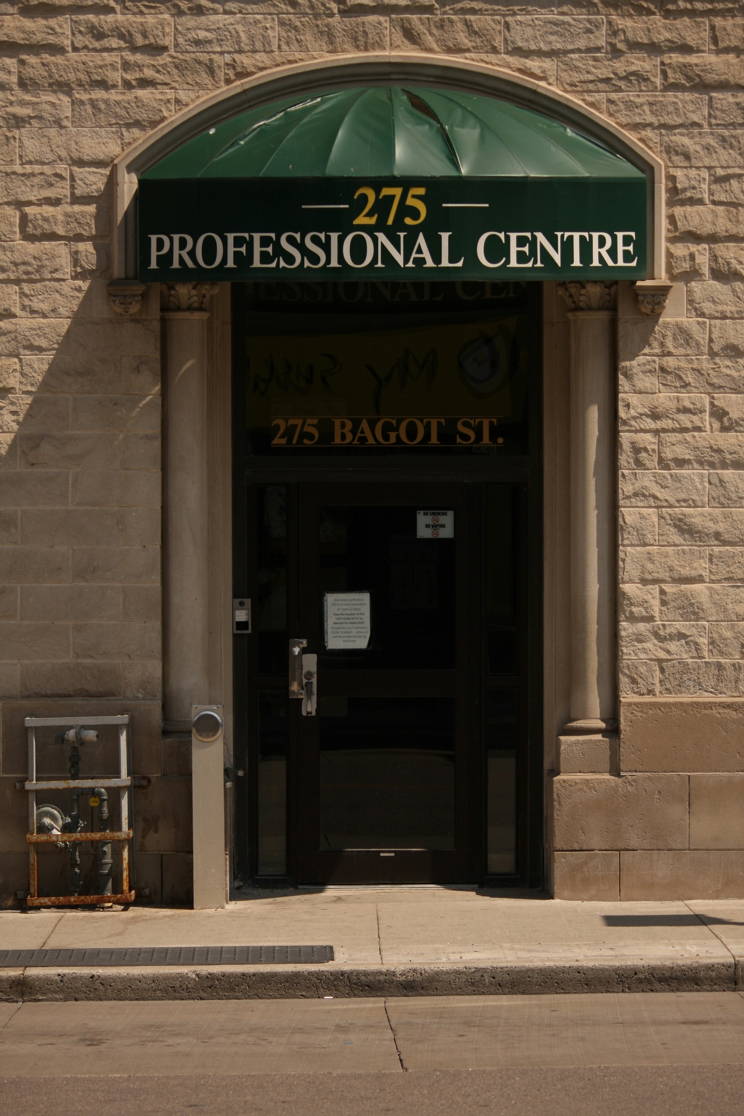 A building with a green awning on the front of it