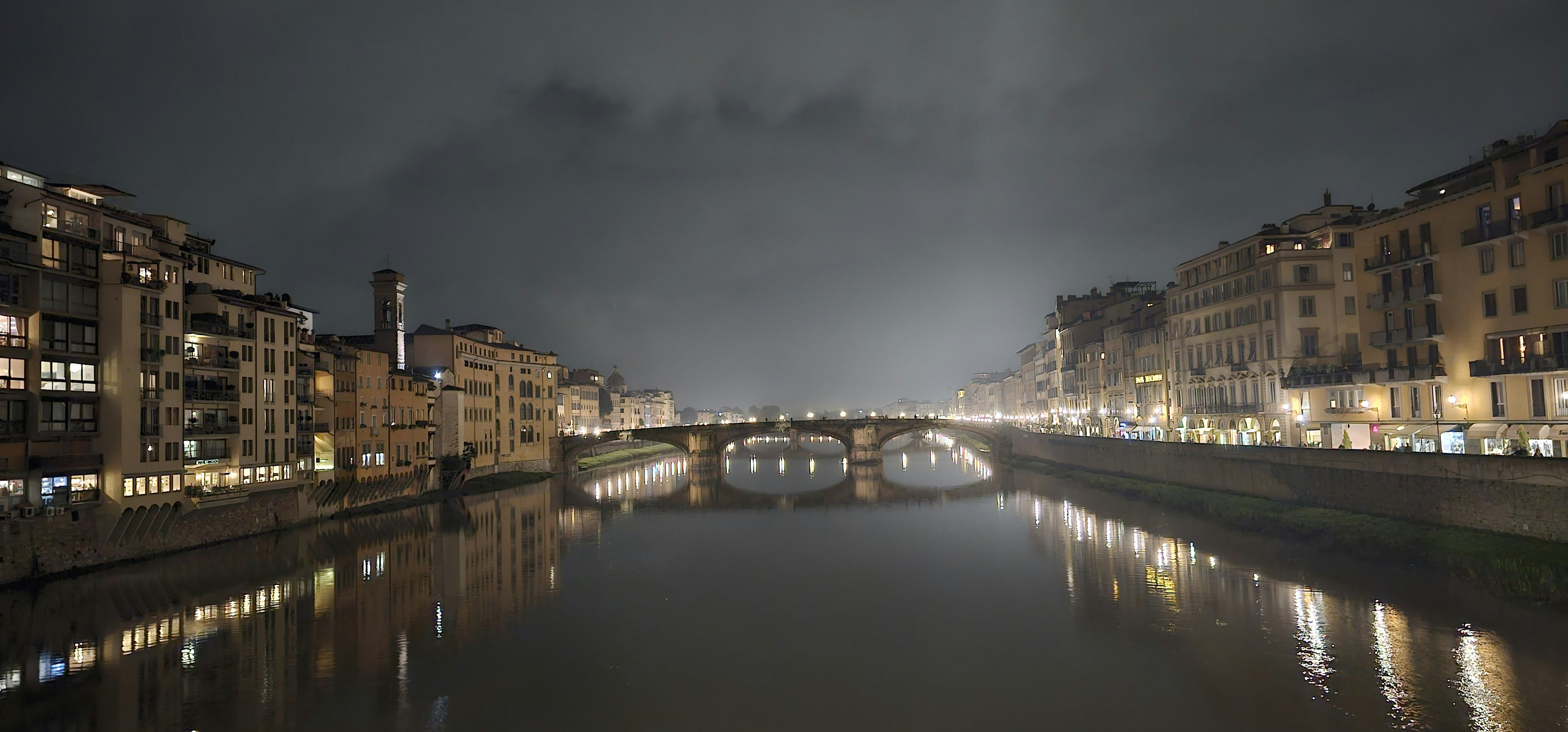 A river running through a city next to tall buildings