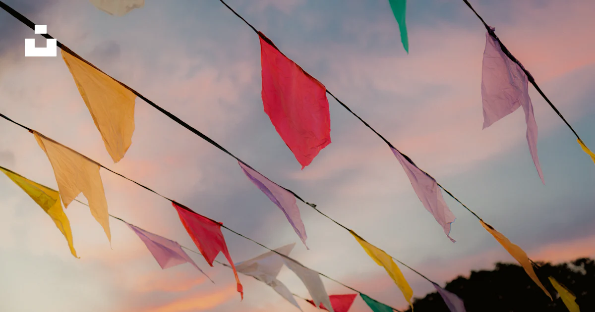 Flying Color Flags A group of colorful flags flying in the sky photo – Free Festa julina ...
