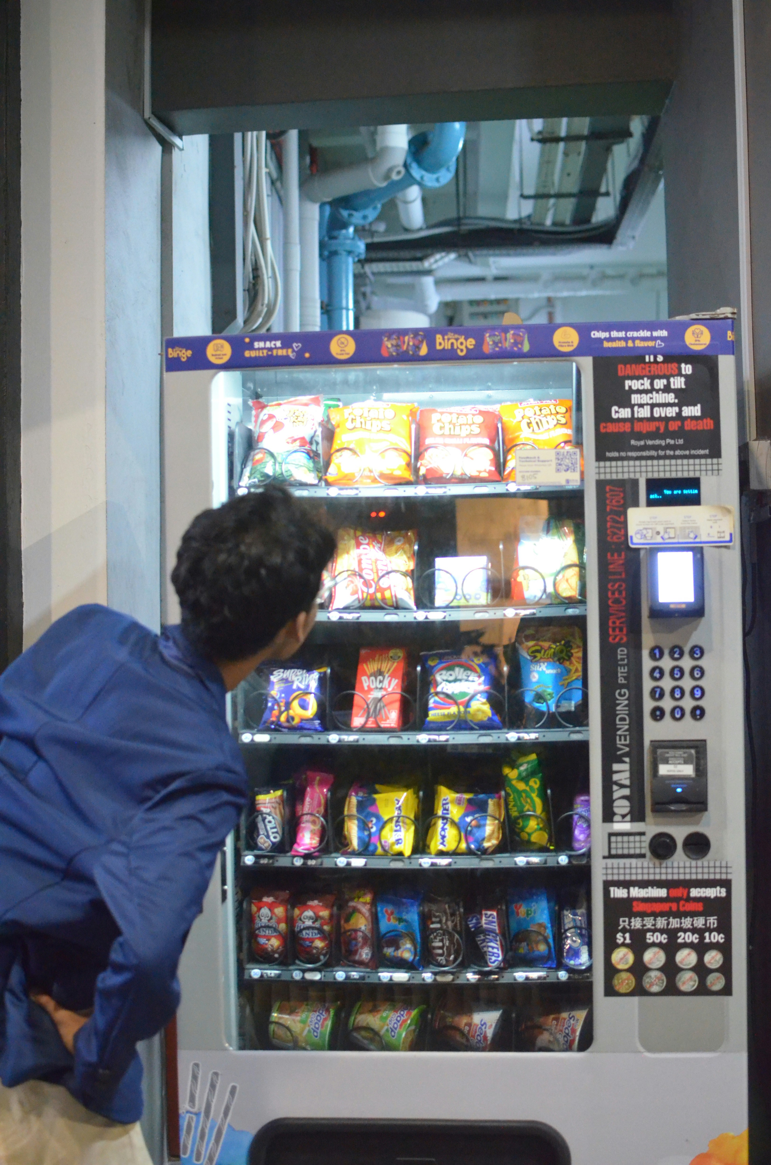Close-up of snack vending machine touchscreen interface showing colorful product selection options