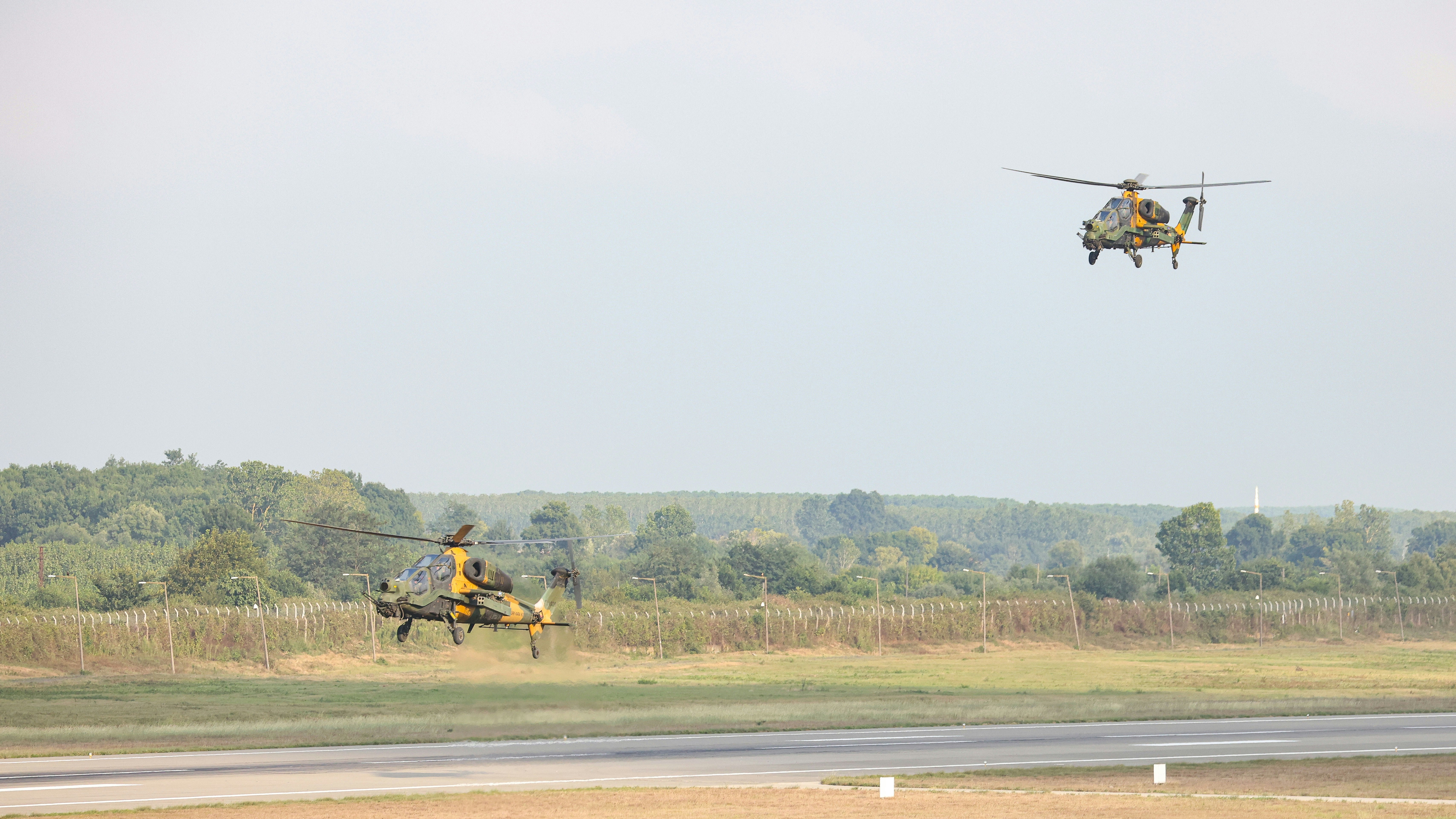 A helicopter flying over a field with a man on a horse