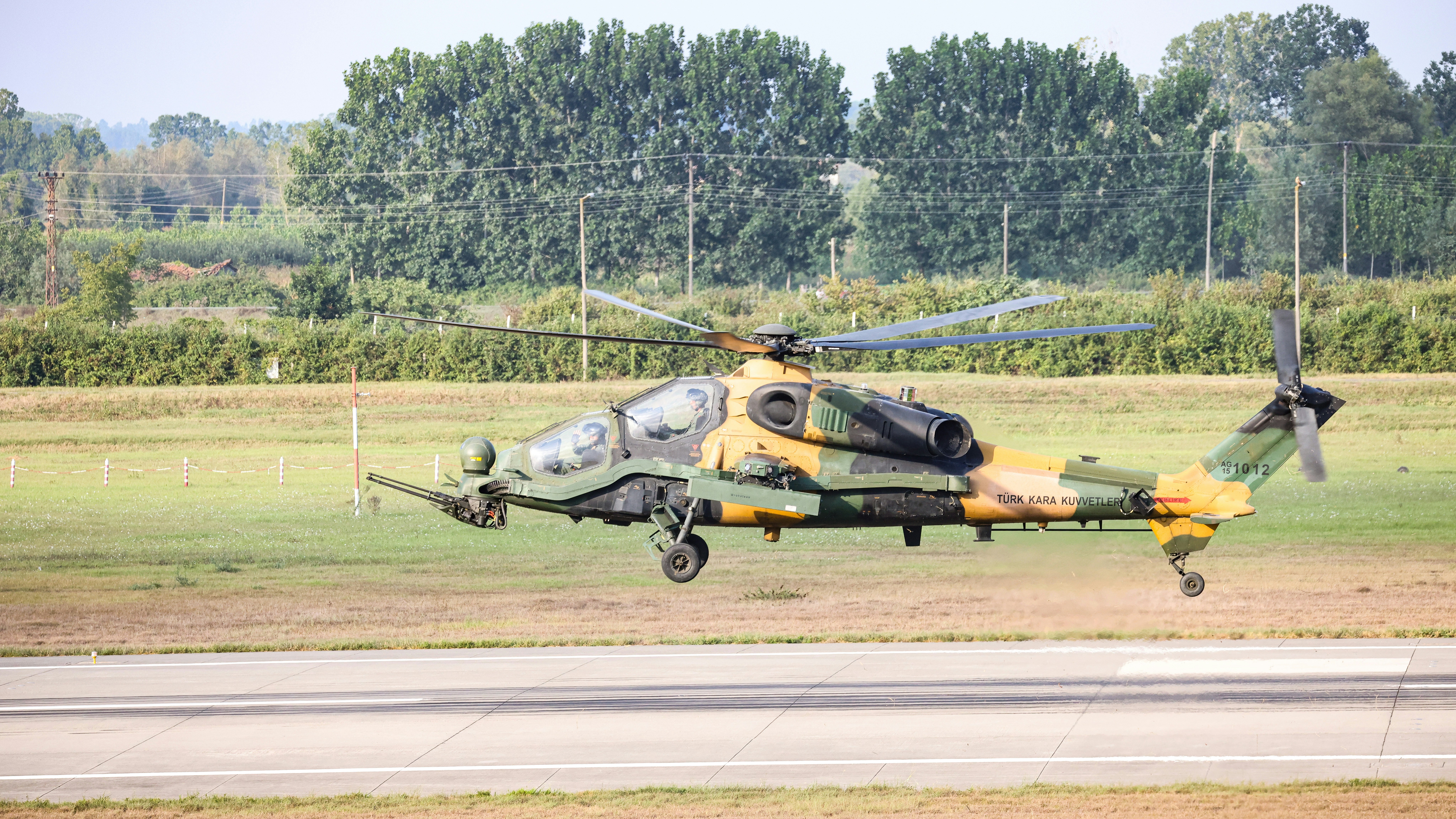 A military helicopter taking off from a runway