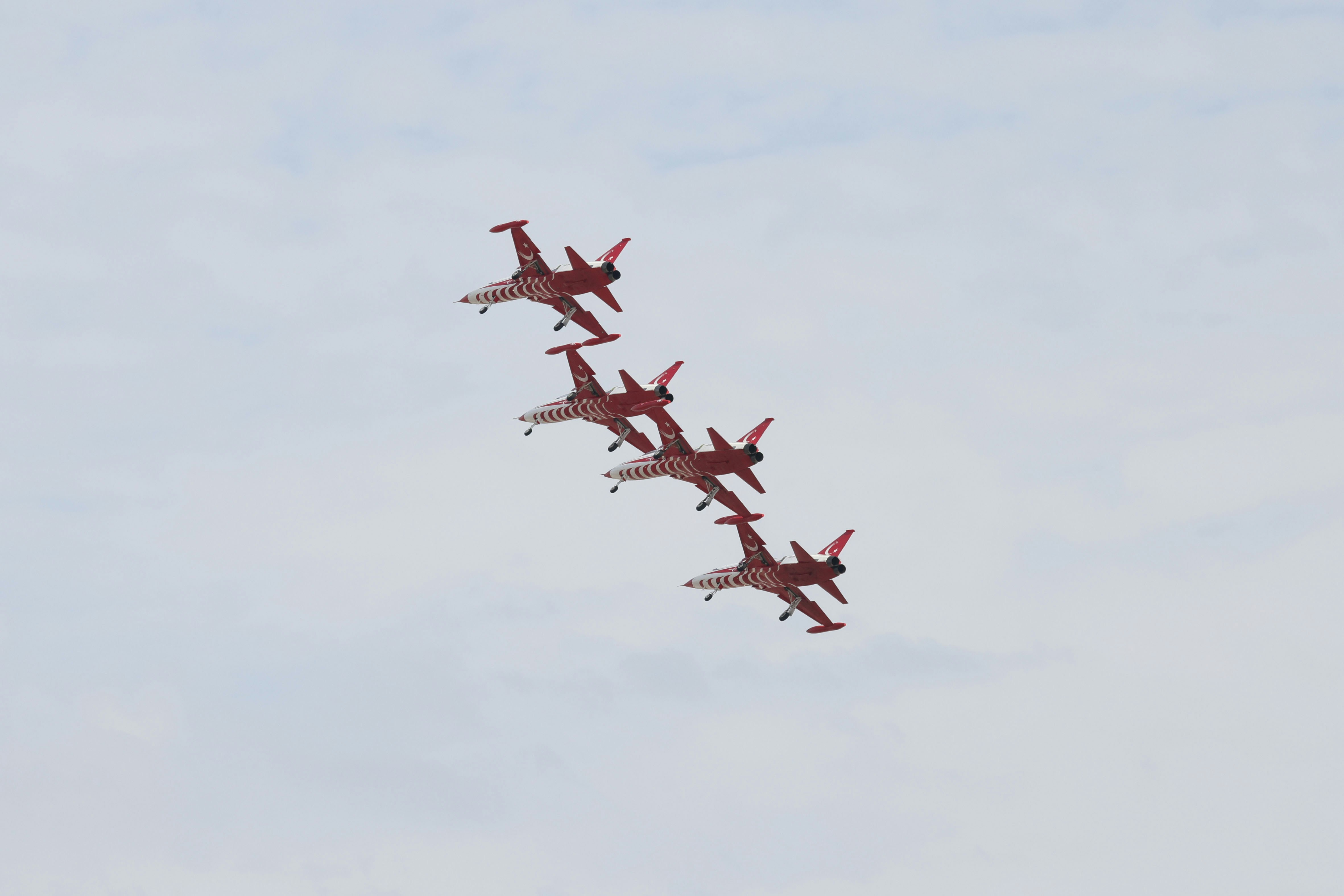 A group of airplanes flying in formation in the sky