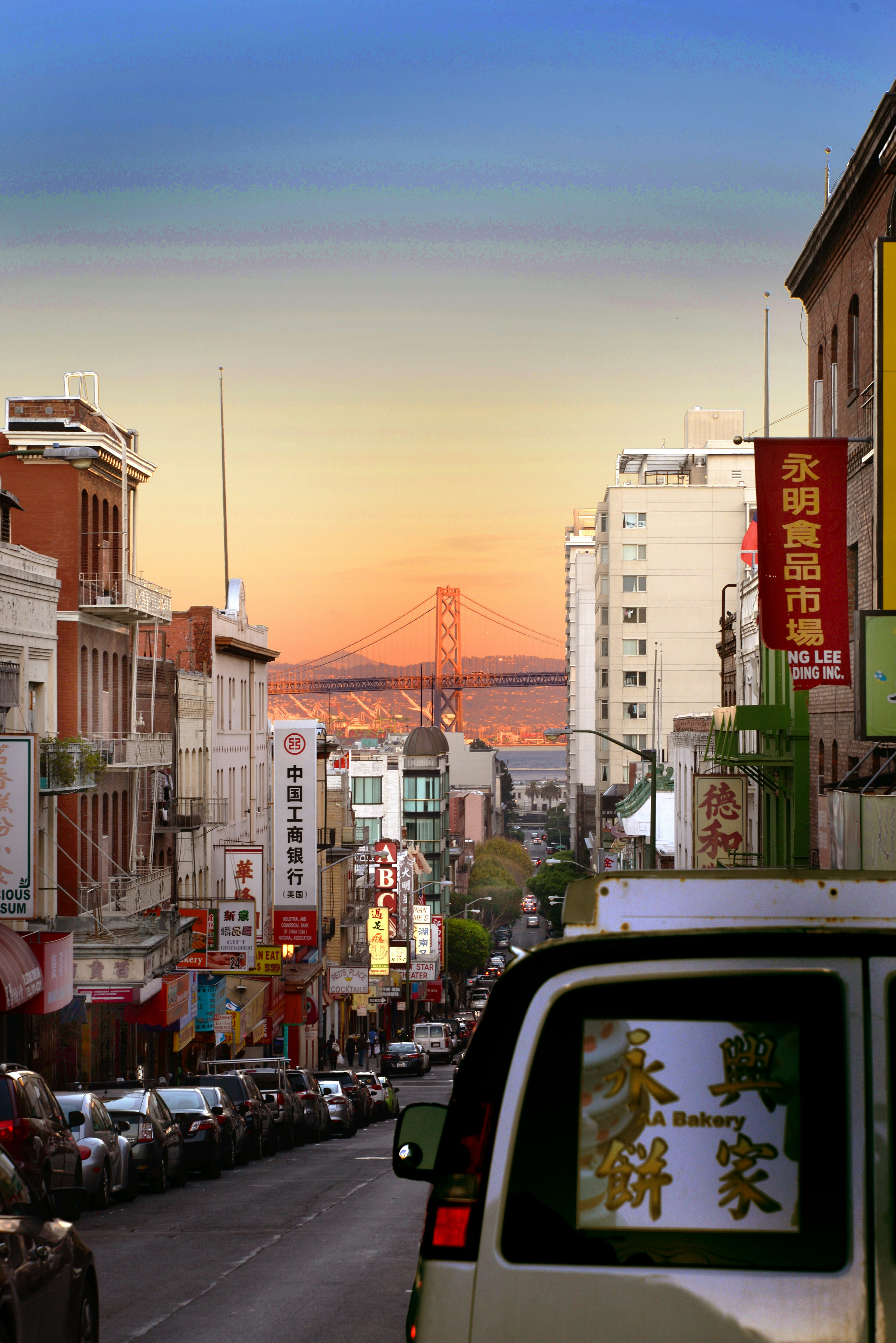 A city street filled with lots of traffic next to tall buildings
