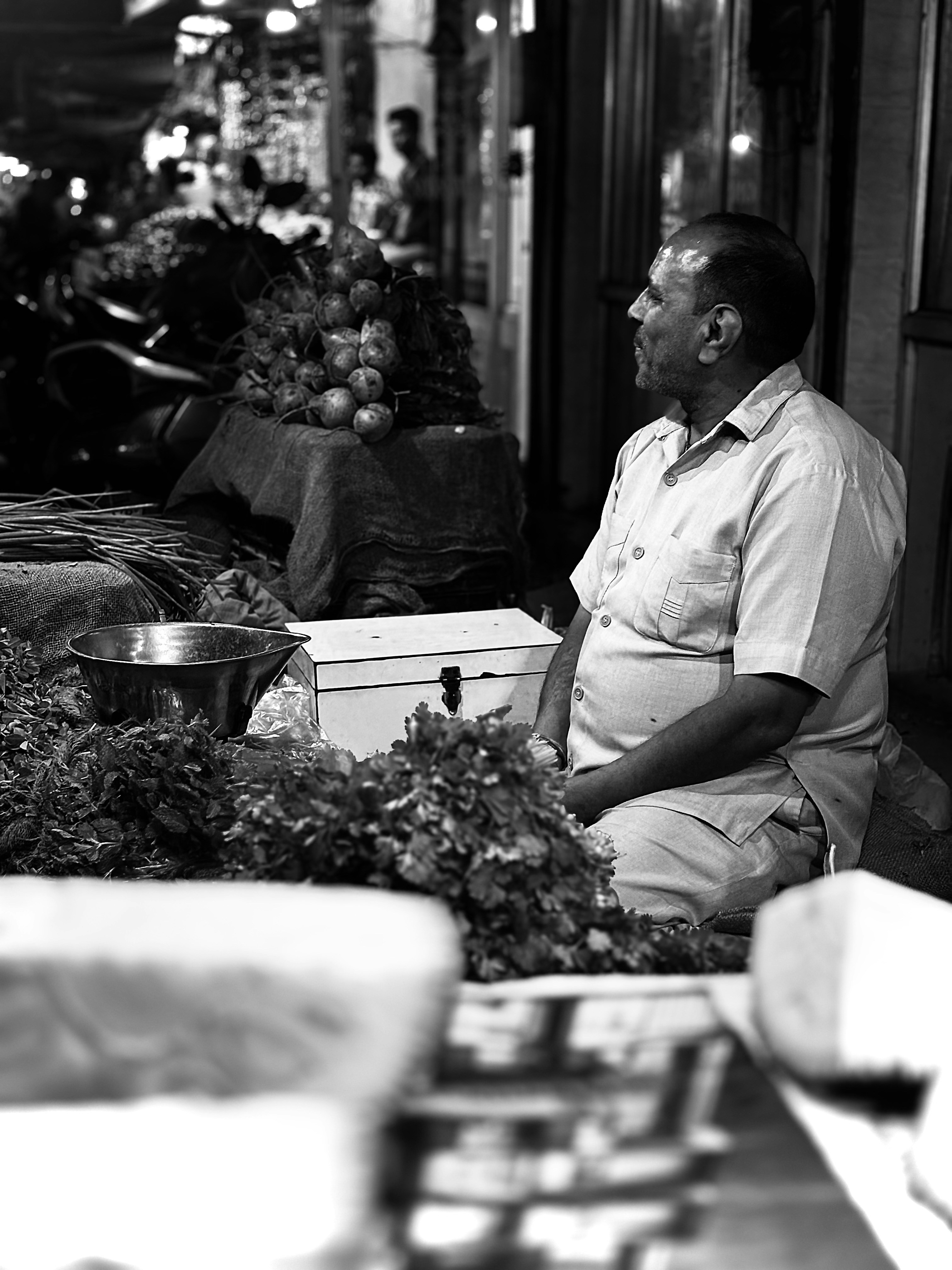 A man sitting on a bench in front of a store