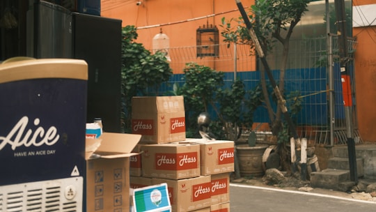 Boxes are stacked up on the side of the street