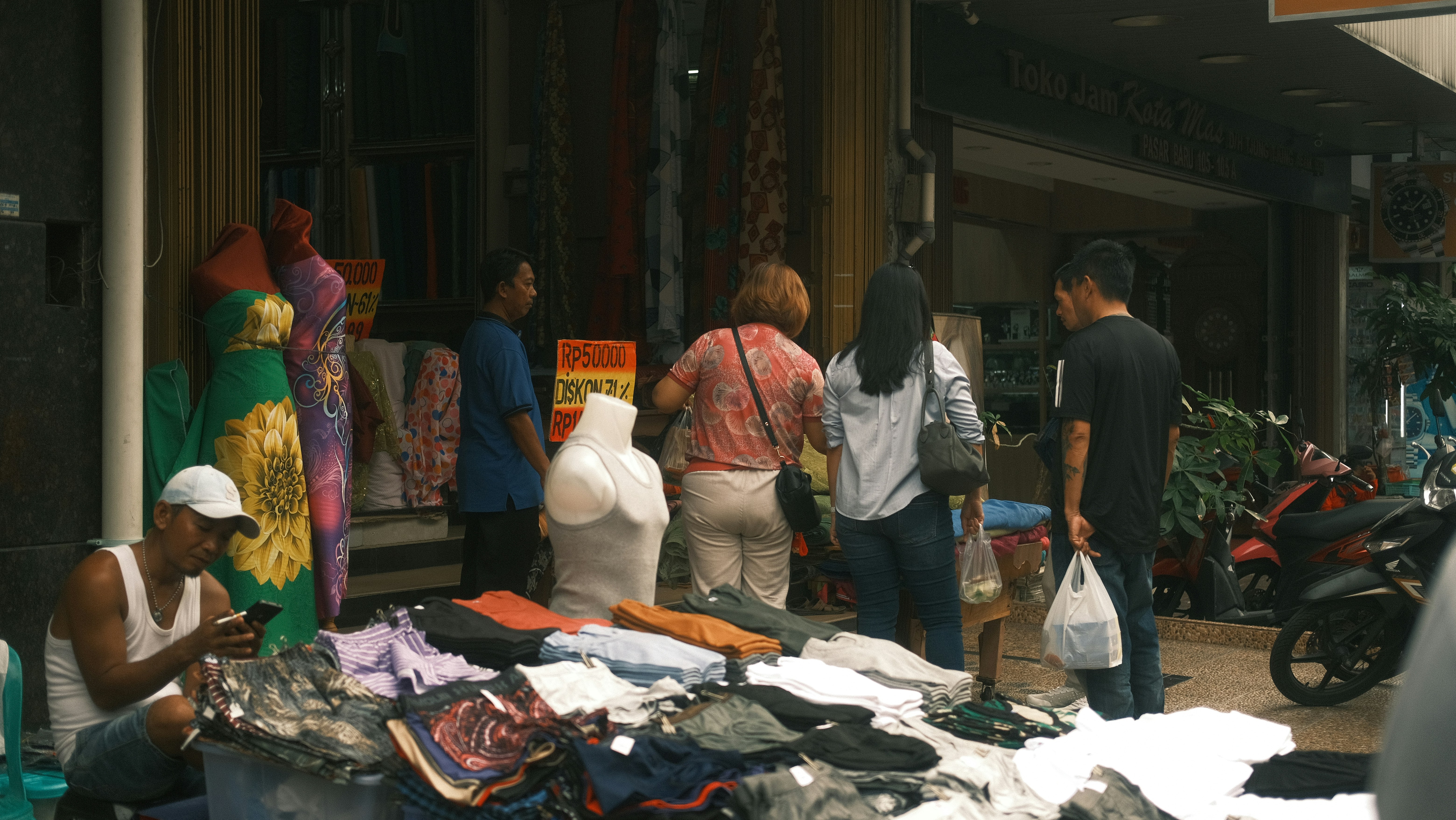 Sekelompok orang berdiri di luar toko