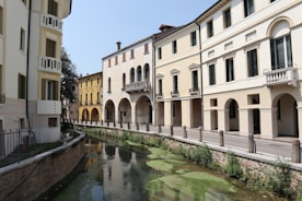 A river running through a city next to tall buildings