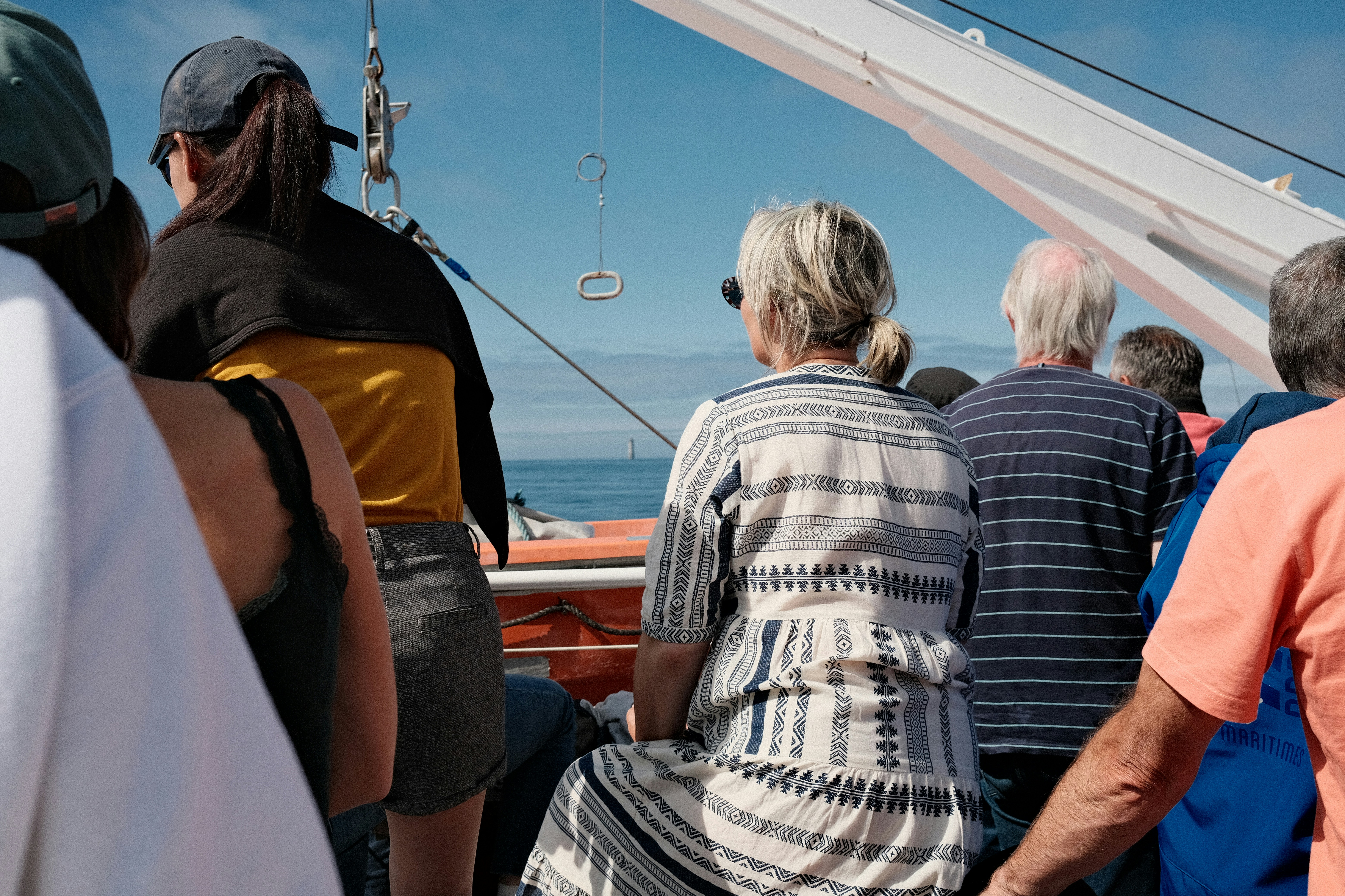 Tourists observing whales on a Molokini tour boat