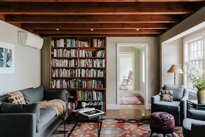 A living room filled with furniture and a book shelf