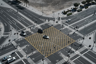 An aerial view of a city intersection with a yellow square