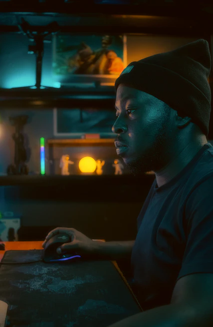 A man sitting at a table with a computer mouse