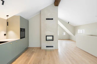 An empty room with wood floors and white walls