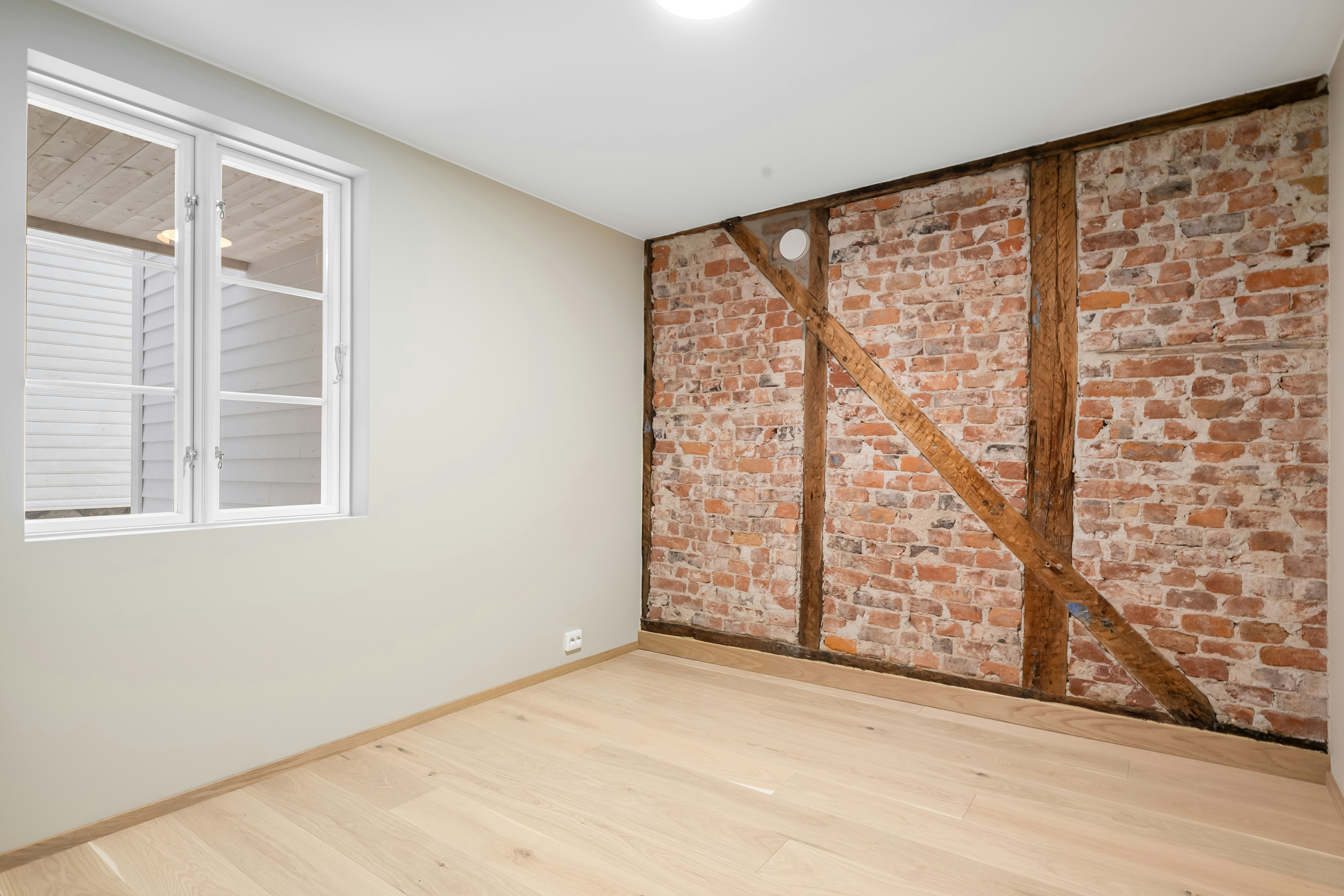 Empty room with exposed brick wall